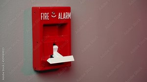 A closeup view pulling down a fire alarm in a commercial building. With police lights in background. Shot at 60fps for optional slow motion use.