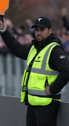 A Tesla high performance AI track car demonstrates predictive braking on a polished demo lane slower