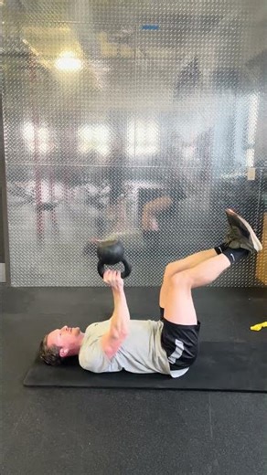 Bottoms Up Single Kettlebell Floor Press with Legs Raised