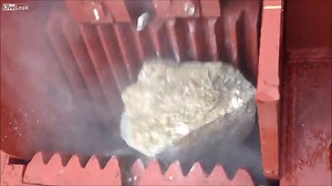 Captivating Footage of Industrial Rock Crushing Machines Quickly Turning Large Stones Into Gravel