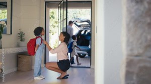 Family at home with parents getting children ready to leave house and go to school