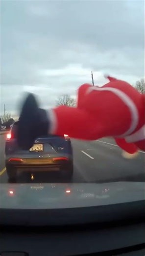 Dashcam Captures Giant Santa Rolling Across Busy Road
