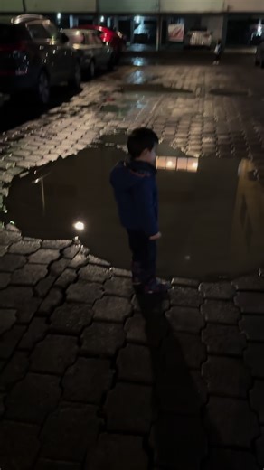 Child Enjoys Splashing in Puddles with New Rain Boots