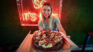 Nestled in the quaint town of Nottingham, England lies Britain's BIGGEST Donut! Crafted by the evil bakers of Doughnott's, the 14 inch "Monster" Donut features over 3 kilos of donut base topped with all sorts of traditional British chocolates. My variety featured loads of fresh buttercream, chocolate dodgers, Kinder Hippos, Reese's PB Cups, Galaxy Bars, Smarties, Toffee Crisp Bars, Kinder Bars, and Flipz Pretzels and was filled with even more caramel and peanut butter! Challengers have 40 minute