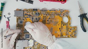 Inside view of hardware component. PCB printed circuit board extreme close up. A PCB. Repair of laptops and computer motherboards. Yellow circuit board laptop. Chip on a printed circuit board.