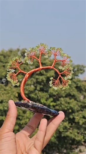 ＡＲＳＩＮＡＧＡＴＥ＆ＧＥＭＳ✨🌈 on Instagram: "That is a beautiful piece of craftsmanship! What you’re looking at is a Gemstone Wire Tree (often called a "Tree of Life" or "Feng Shui Tree") mounted on a natural stone base. Based on the colors and textures in the image, here is a breakdown of the materials likely used: Component Breakdown * The "Leaves": These appear to be Peridot or Green Aventurine chips. Peridot is known for that specific lime-green, translucent glow, while Aventurine is usually slightly m