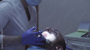 Dentist making the patient an anesthetizing injection