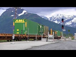 A long Alaska railroad freight train slowly passes through Portage, Alaska.