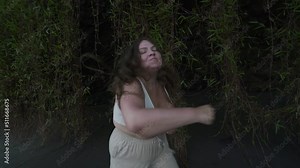 Curvy plus size girl doing shadow boxing at the beach. Owerweight women are exercising with boxing. Concept of sport, lifestyle and health.
