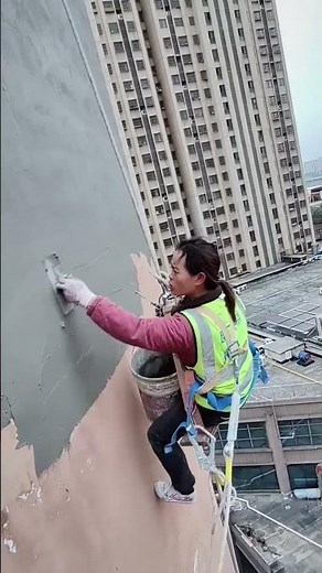 Fearless Woman Handling High-Rise Building Exterior Finishing Work