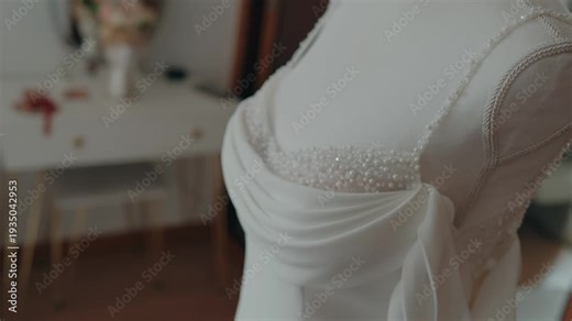 White bridal gown bodice with bead detail and draped fabric