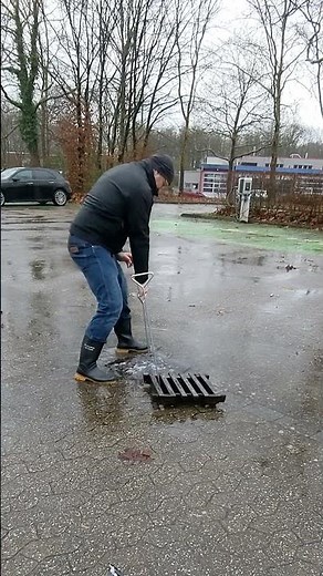 S#059-1 Unclogging a storm drain during rain in Germany, #shorts