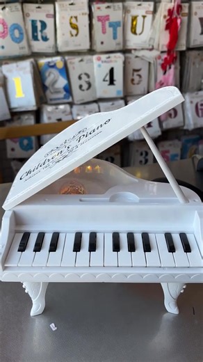 🎹This is a Miniature Grand Piano Toy for children. Design: Modeled after a white baby grand piano. Keys & Features: It is an electronic keyboard, typically featuring 24 keys, various musical effects, built-in songs, and sometimes a microphone. Benefit: Promotes early musical interest, auditory memory, and brain stimulation. | Libsun- লিবসুন