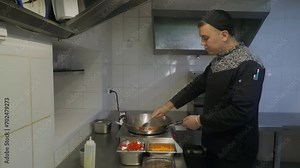 Restaurant Chef Cooking Appetizing Asian Cuisine Food By Stir Frying Ingredients. Cooking Delicious Asian Food In Chinese Wok Cooking Pot. Cooking Tasty Asian Food Noodles. Professional Preparation