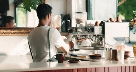 clip-4031448521-barista-man-steam-milk-coffee-machine-customer