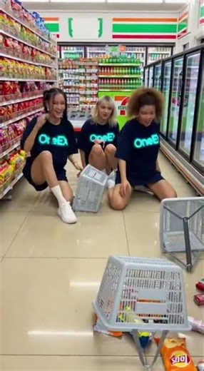 Three girls in matching navy blue (#0A1E3C) OneEx oversized t-shirts with cyan (#00D9FF) logo (shir