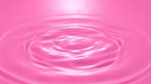 Download Water Droplet Splash on Pink Surface Creates Ripples, Captured in Studio Lighting for free