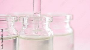 In a cosmetics laboratory pipette draws up and dispense liquid into the test tubes. Concept of cosmetics, research, biochemistry, pharmaceutical
