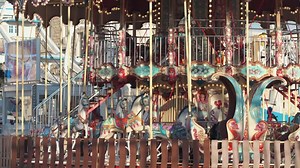 Colorful Carousel Spins Joyfully at a Vibrant Fairground in the Afternoon Sun