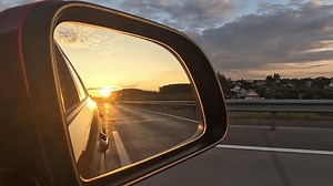 clip-3431559339-sun-reflected-mirror-evening-road-view-rear