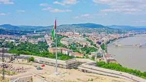 The aerial view of Budapest's city center showcases the iconic Danube river flowing through the heart of the city, with stunning view of Liberty bridge and Liberty statue