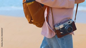 young girl with a camera. girl walks with a camera. camera close-up. Fashionable and attractive beautiful woman travels. travel and vacation.