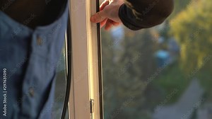The professional master changes the rubber gaskets and seals on the pvc window. Preparing for winter, warming the house. Window repair. Window sealing