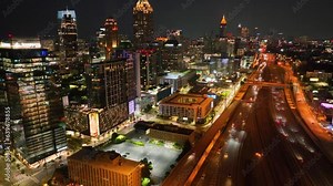 Aerial night footage of Atlanta skyline and highways, cars and builds shot from drone