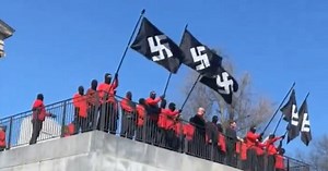 Masked demonstrators wave Nazi flags in front of Tennessee capitol