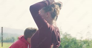 Young couple relaxing and having fun after jogging on country road