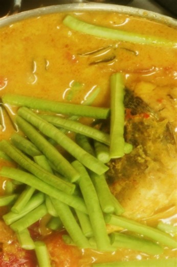 Singapore fish head curry with vegetables and poached fish