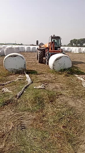 Tractor Baling Hay in Rural Agriculture Scene
