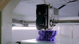 Process of printing physical plastic model of purple toy castle on automatic 3d printer machine. Additive technologies, 4.0 industrial revolution, 3D printing and prototyping industry concept