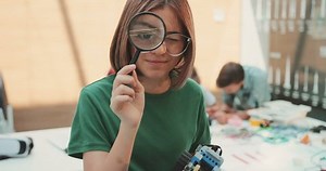 clip-31727680-girl-looking-into-camera-through-magnifying-glass