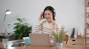 clip-3576861197-happy-young-beautiful-asian-woman-smile-using