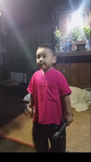 Child Simulates Singing with Microphone Indoors