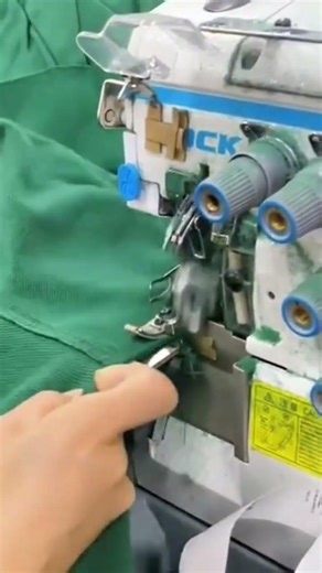 Sewing a green fabric edge using a professional electric overlock machine neat and perfect finish