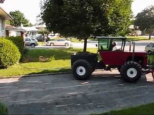 Homemade tractor pulling the neighbour's bushes