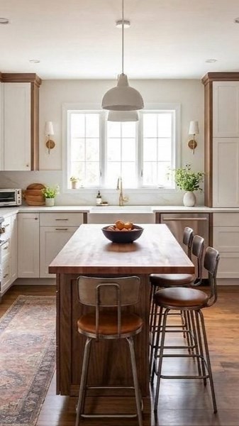 Navy cabinetry meets warm walnut in this kitchen transformation. The bold two-tone look gets swapped for a softer, more cohesive palette—cream uppers with rich wood tones throughout, letting the architecture breathe. #kitchen_transformation #before_and_after #kitchen_design #walnut_cabinetry #kitchen_renovation #two_tone_kitchen #home_design #kitchen_inspiration