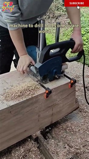 A carpenter uses a portable mortise and tenon machine to drill holes on square wood