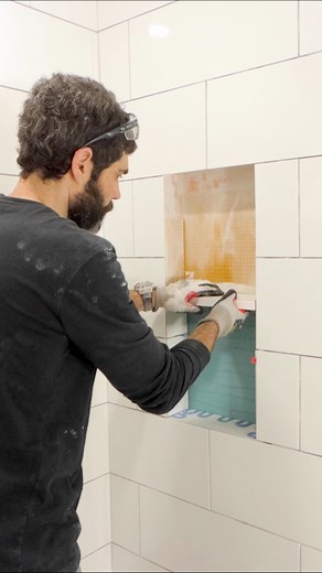 Shower niche shelf tips…I apply thin-set mortar to the top of tiles inside my niche. Then I carefully set the shelf. Be careful. It’s very easy to chip tiles when doing this. I ensure the shelf is level left to right. But I pitch it slightly (1/16” at most) so water drains toward the shower. Make your shower remodel easier with our Video Library at homerepairtutor.com 👍🏽🔥#tileshower #bathroomremodel #diy #homerepairtutor | Home Repair Tutor