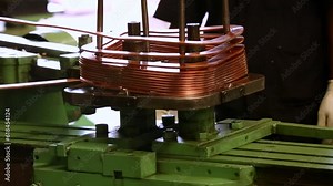 Copper wire folding on a square roll.