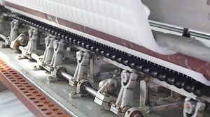 Textile industry. Loom machine close up. Process of mattress production