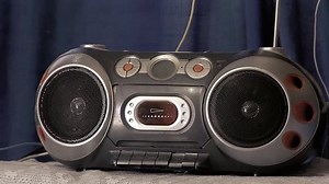 clip-1022107498-man-turning-on-old-radio-his-home