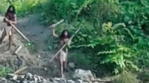 Shocking moment uncontacted tribe have terrifying stand-off with mine bulldozer