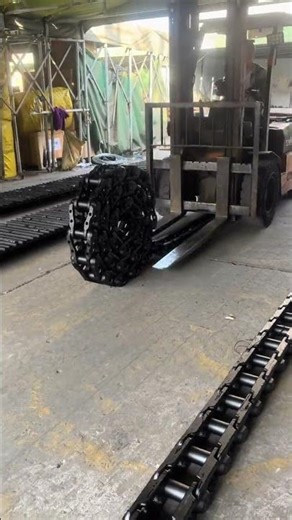 Coiled excavator track chain unwinding process