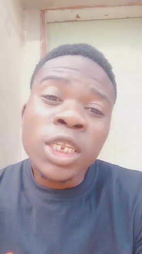 Person in Dark Shirt Against Light Wall