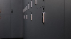 Nice school changing room interior. Men's dressing room with blue metal lockers in the college gym. American locker room gym school interior. Office wardrobe, locker room in sport club. Dressing room