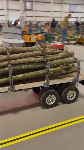 RC tractor trailer hauling logs at Cabin Fever Expo