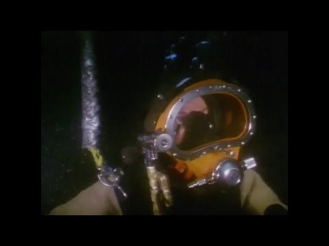 A female scuba diver in heavy scuba gear in peril!